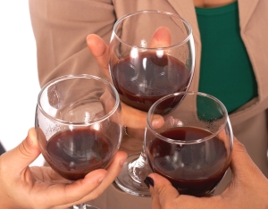 Three People Celebrating With A Glass Of Wine